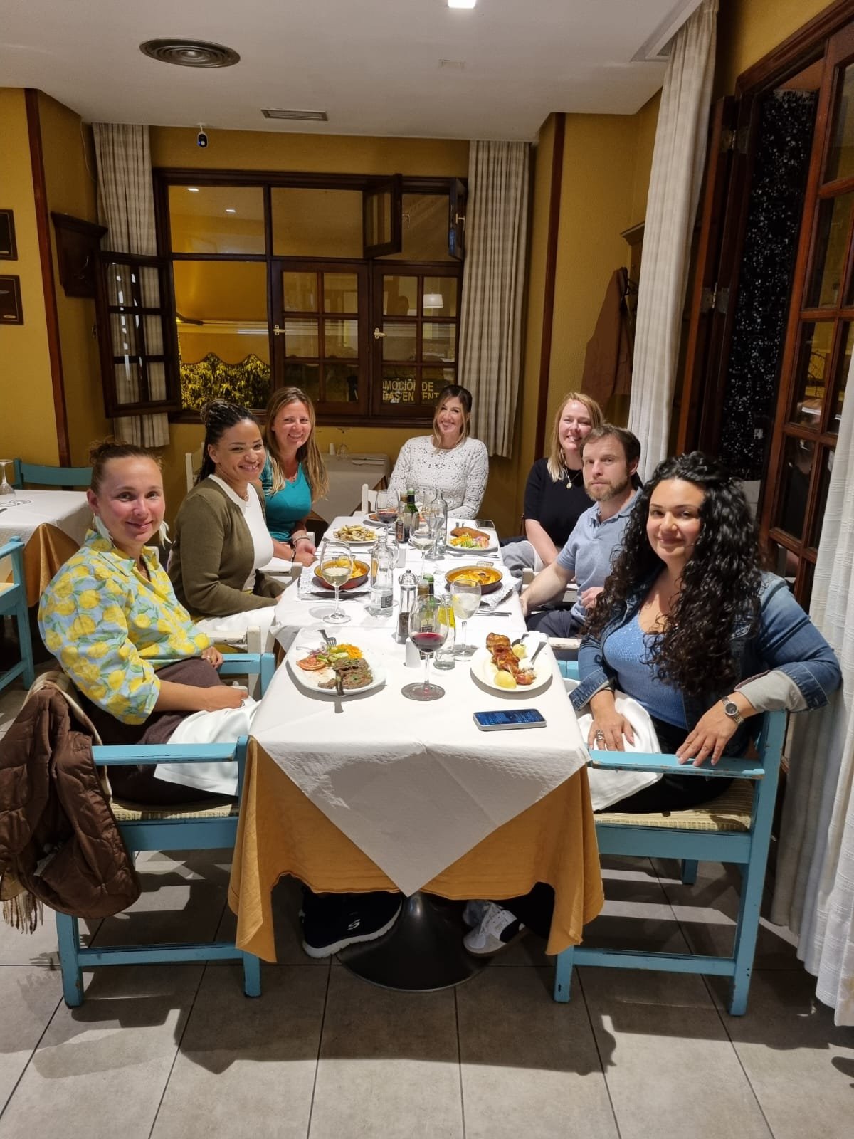 A Friendchise group sharing a meal at a restaurant